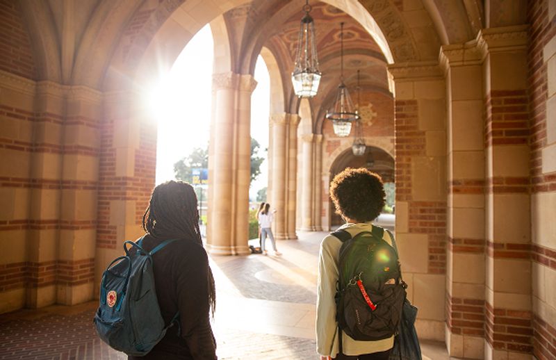 Two students standing in UCLA Royce Hall.