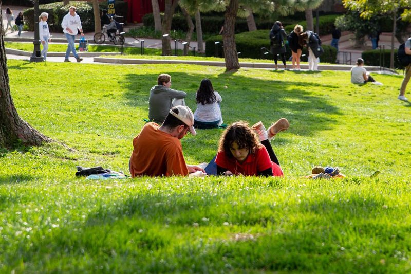 Two students relaxing in the grass on campus