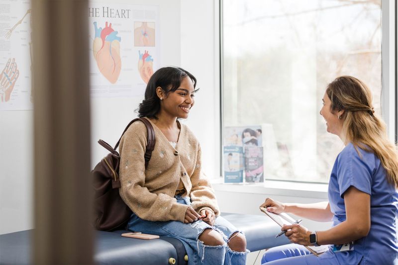 A patient and nurse at an exam table