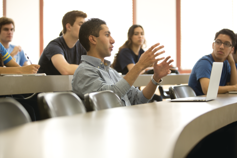 A male student is speaking in a classroom setting in Dodd Hall 175