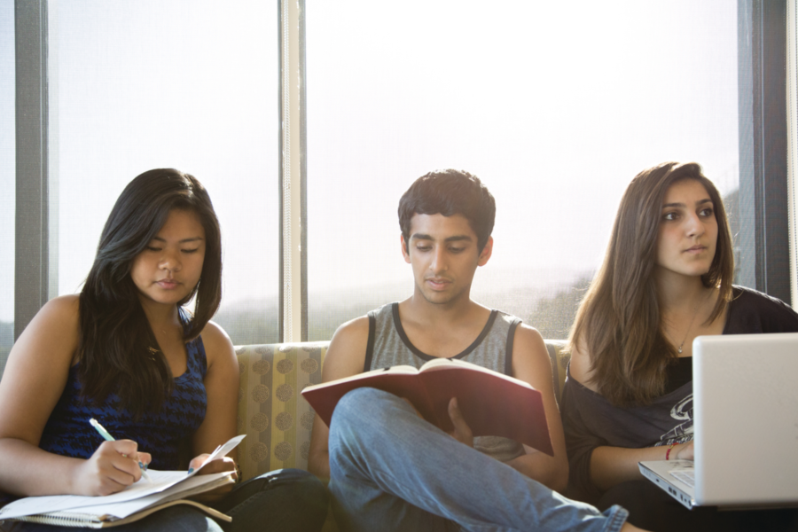Three students study in the lounge of Gardenia Way, one of the De Neve Plaza residence halls.