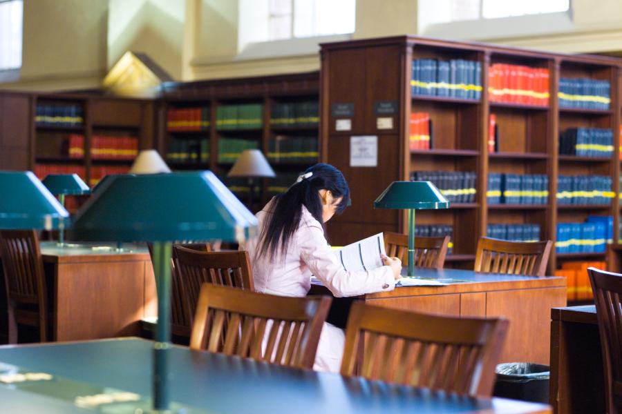 Picture of a female student studying in a library on UCLA's campus